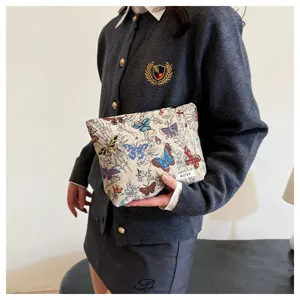 Woven fabric makeup bag with colorful butterfly pattern, stylish versatile storage pouch for women.