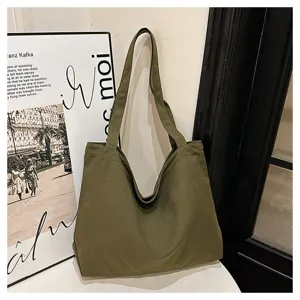 Green canvas tote bag detail, casual minimalist shoulder bag for daily shopping and travel use.