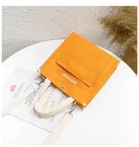 Orange canvas tote bag with front pocket casual shoulder handbag for students and daily use