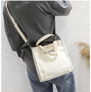 Casual canvas shoulder bag for women, retro Japanese style tote handbag with letter print.