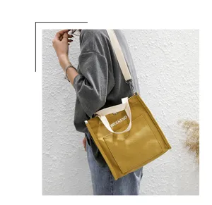 Yellow canvas shoulder bag for women, student casual tote bag with letter print design.