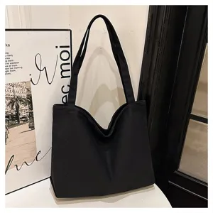 Minimalist black canvas tote bag for women, large capacity casual shoulder bag for daily use.
