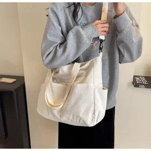 Casual corduroy shoulder bag with large capacity, multiple pockets and stylish daily design.