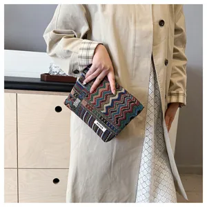 Ethnic style fabric cosmetic bag, retro geometric woven pattern makeup organizer pouch detail.