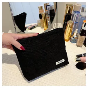 Black corduroy cosmetic bag for women, portable storage pouch, minimalist clutch bag.