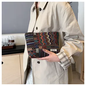 Close-up detail of ethnic woven cosmetic storage pouch with geometric pattern design.