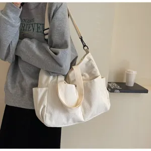 Detail view of the casual white corduroy shoulder tote bag, featuring spacious capacity and soft fabric.
