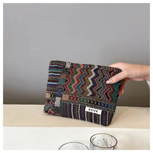 Ethnic woven cosmetic pouch, colorful geometric pattern makeup bag, versatile storage clutch.