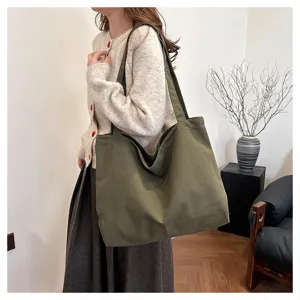 Detail shot of the large canvas tote bag showing the spacious interior and shoulder strap design.