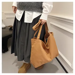 Brown canvas tote bag detail view, casual large capacity shoulder bag for daily use.
