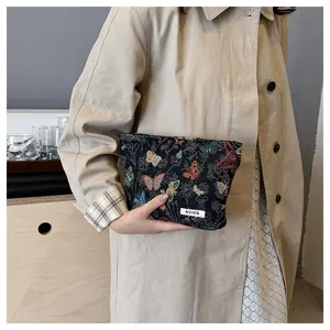Stylish women woven cosmetic bag with butterfly pattern, elegant hand clutch for daily use.