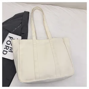 Detail view of a large capacity white canvas tote bag, versatile shoulder and handbag for daily use.