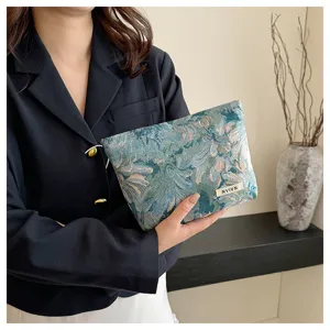 Retro floral woven cosmetic bag, stylish vintage makeup pouch for women daily use and travel storage.