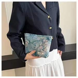 Detailed view of the vintage woven tapestry cosmetic pouch, featuring floral fabric design.