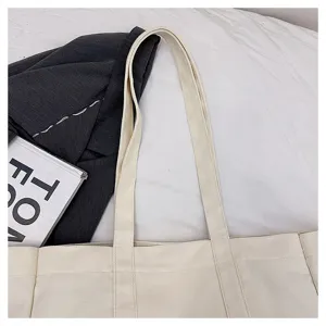 Canvas tote bag strap detail, premium fabric texture and neat stitching close-up view.