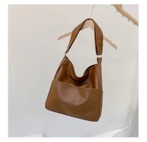 Close-up view of a casual brown PU leather shoulder bag with stitching and front pocket detail.