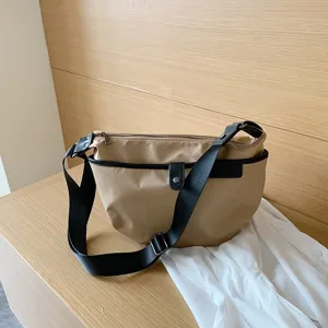 Casual nylon crossbody bag for women, stylish khaki shoulder bag with wide strap.