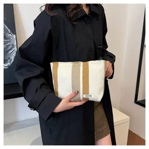 Striped canvas cosmetic bag, large capacity portable storage pouch, casual women's clutch.