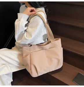 Casual solid color canvas shoulder tote bag with multiple pockets for daily use detail view.