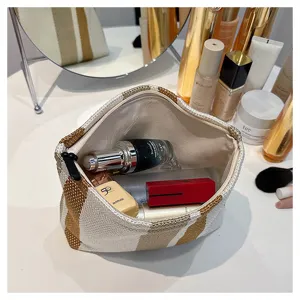 Detailed shot of a stylish striped canvas cosmetic bag, large capacity makeup storage pouch.
