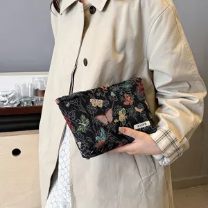 Detailed view of the stylish black butterfly print linen makeup pouch, showing texture and design.