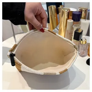 Detail view of the spacious interior and striped canvas material of the portable cosmetic pouch.