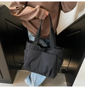 Black canvas tote bag with multiple pockets, casual shoulder bag for women daily use.