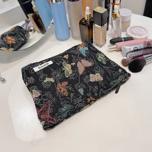 Black vintage butterfly woven cosmetic bag, large capacity canvas makeup storage pouch detail view.