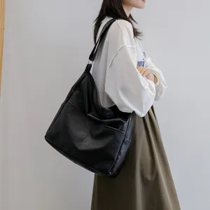 Casual black PU leather shoulder bag for women, stylish slouchy tote with spacious interior.