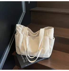 Detailed view of the minimalist solid color canvas tote shoulder bag for women, fashion casual.