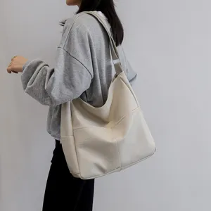 Casual PU leather shoulder tote bag for women, slouchy hobo handbag with stitching.