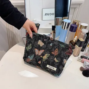 Black woven cosmetic bag with colorful butterfly pattern and large storage capacity for daily use.