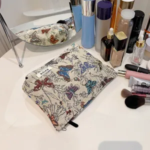 Close-up detail of vintage butterfly tapestry makeup bag showing premium fabric and zipper.