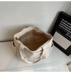 Canvas tote bag interior compartment detail view, minimalist style, practical daily storage.