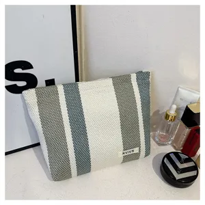 Large capacity striped woven cosmetic bag portable travel storage pouch for women daily use.