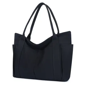 Black canvas tote bag with large capacity, dual shoulder handles and convenient side pockets.