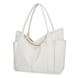 Detailed view of large capacity canvas tote bag with multi-pockets and sturdy handles.