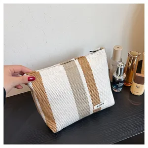 Woven striped cosmetic pouch, large capacity portable toiletry bag, stylish travel makeup bag.