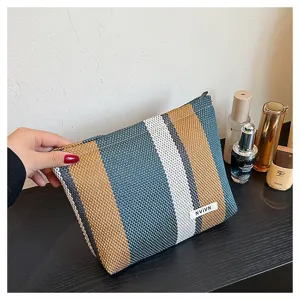 Canvas striped cosmetic bag, large capacity travel makeup pouch, handy daily clutch.