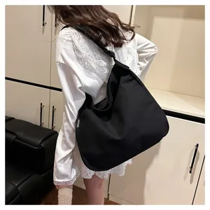 Casual black canvas shoulder bag for women, large capacity stylish tote bag for daily use.