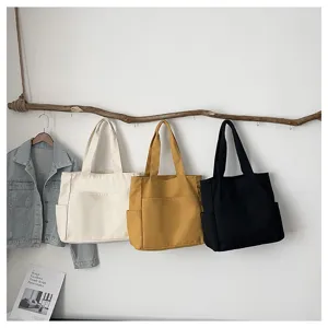 Minimalist solid color canvas tote bag lifestyle detail display showcasing multi-color options.