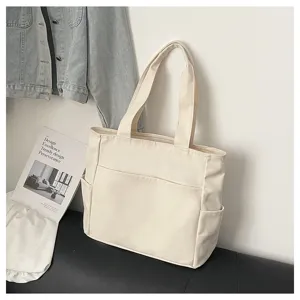 Canvas tote bag detail view, casual multi-pocket design, daily commute practical handbag.