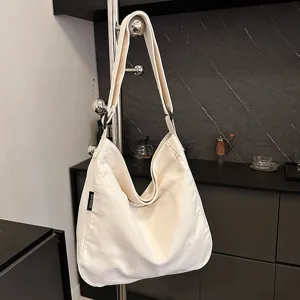 Casual canvas shoulder bag for women, large capacity versatile tote messenger bag.