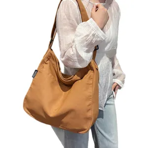 Versatile canvas shoulder bag for women, large capacity daily tote and stylish crossbody bag.