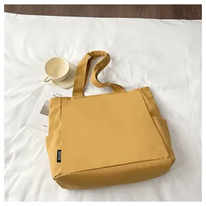 Detailed view of the yellow large-capacity solid canvas tote bag, perfect for daily commute.