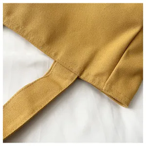 Close up view of yellow canvas tote bag stitching detail, durable fabric handle craft design.