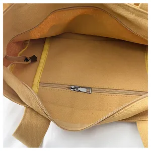 Yellow canvas tote bag interior detail view, casual shoulder handbag with zip pocket.