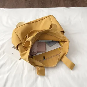 Solid color yellow canvas tote bag large capacity casual shoulder bag for women daily commute.