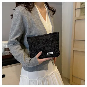 Black floral jacquard cosmetic bag with large capacity, elegant cotton clutch for women.