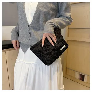 Detailed view of the black crinkled fabric cosmetic pouch highlighting unique texture and style.